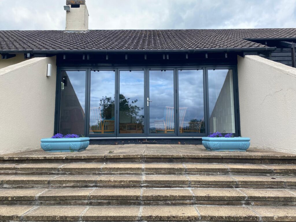 expansive black bi-fold frames looking out to a garden