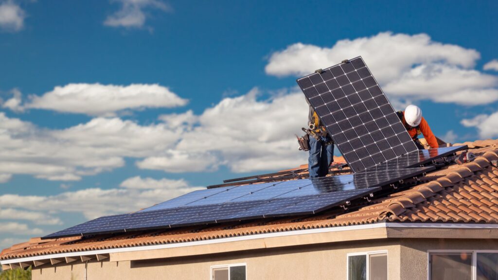 solar panels being fitted on top of a british home to make it more sustainable