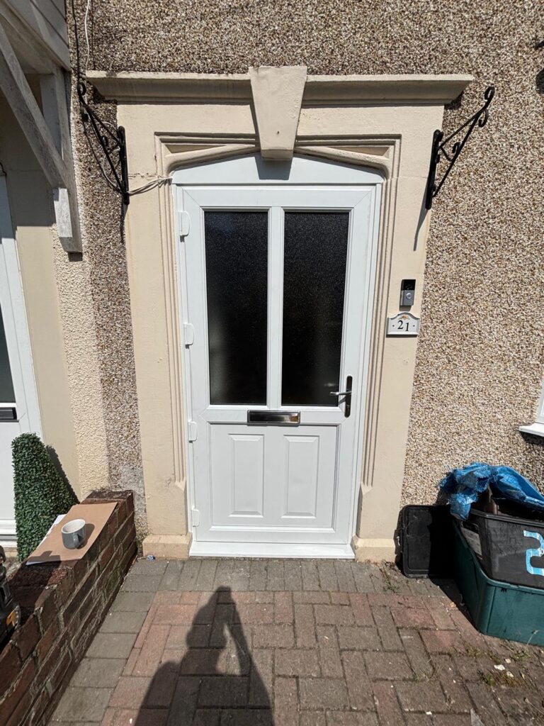 White uPVC arched top front door with frosted glass panels and chrome letterbox.