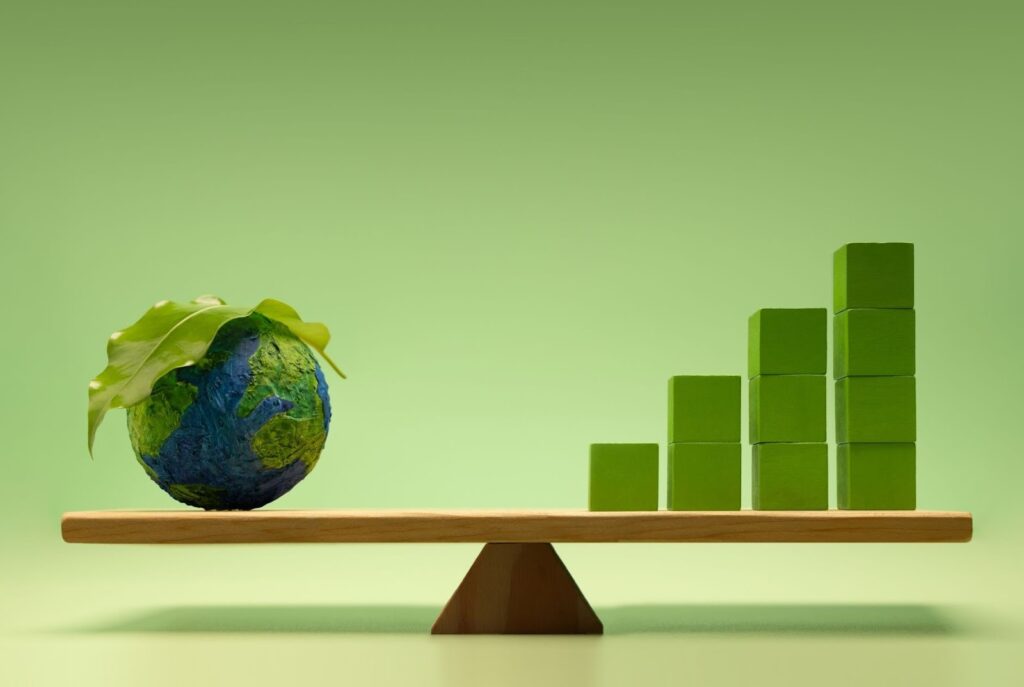 A balanced seesaw, with a felt planet on one side and piled up bricks on the other side